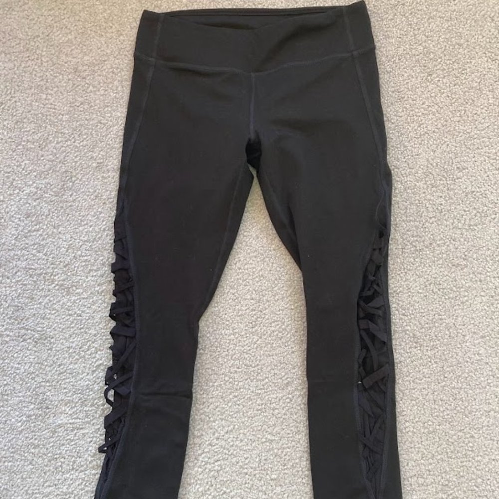Fabletics Size 4 black 7/8 leggings with criss-cross elastic pattern on legs